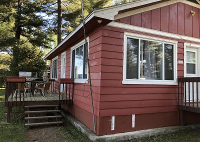 côté extérieur du chalet rouge - Camping canne de bois